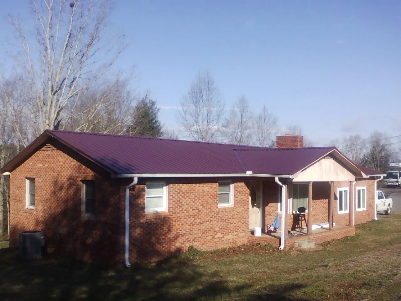Burgundy metal roof on a brick ranch home with a new addition in Middleport